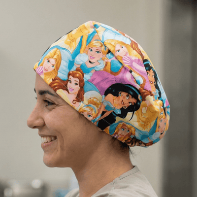 Disney Princesses Crowd scrub cap shown on model