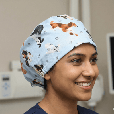 Dog Toss On Light Blue scrub cap shown on model
