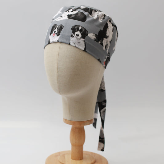 Grey Medicus Scrub Cap featuring a playful Border Collie pattern, displayed on a mannequin head with tie-back detail.