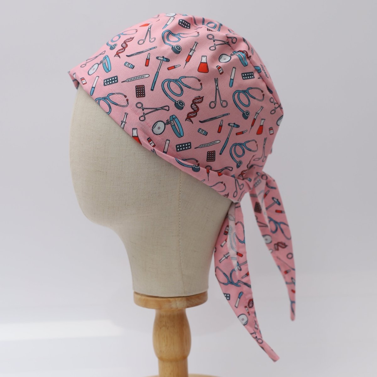 Herramientas de hospital sobre gorro de quirófano rosa
