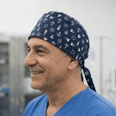 Navy blue nautical scrub cap with white anchors ships lighthouses worn by smiling healthcare worker