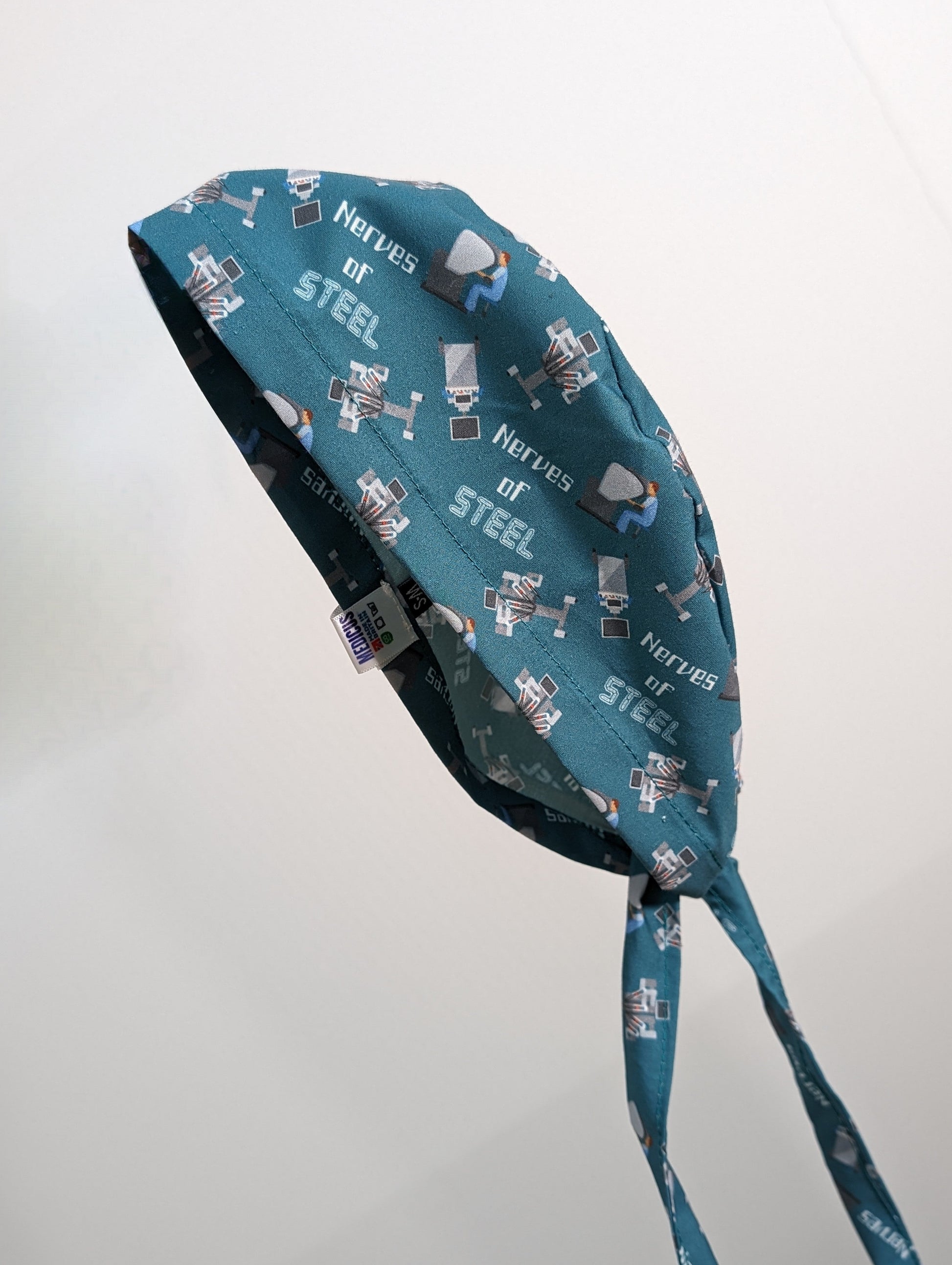 The Medicus Scrub Caps Robotic Surgery Nerves of Steel Green Scrub Cap features robotic designs with "Nerves of Steel" text, perfect for surgical professionals.