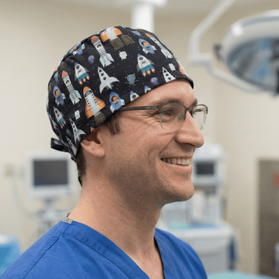 Black space rocket pattern scrub cap with colourful spaceships and planets design