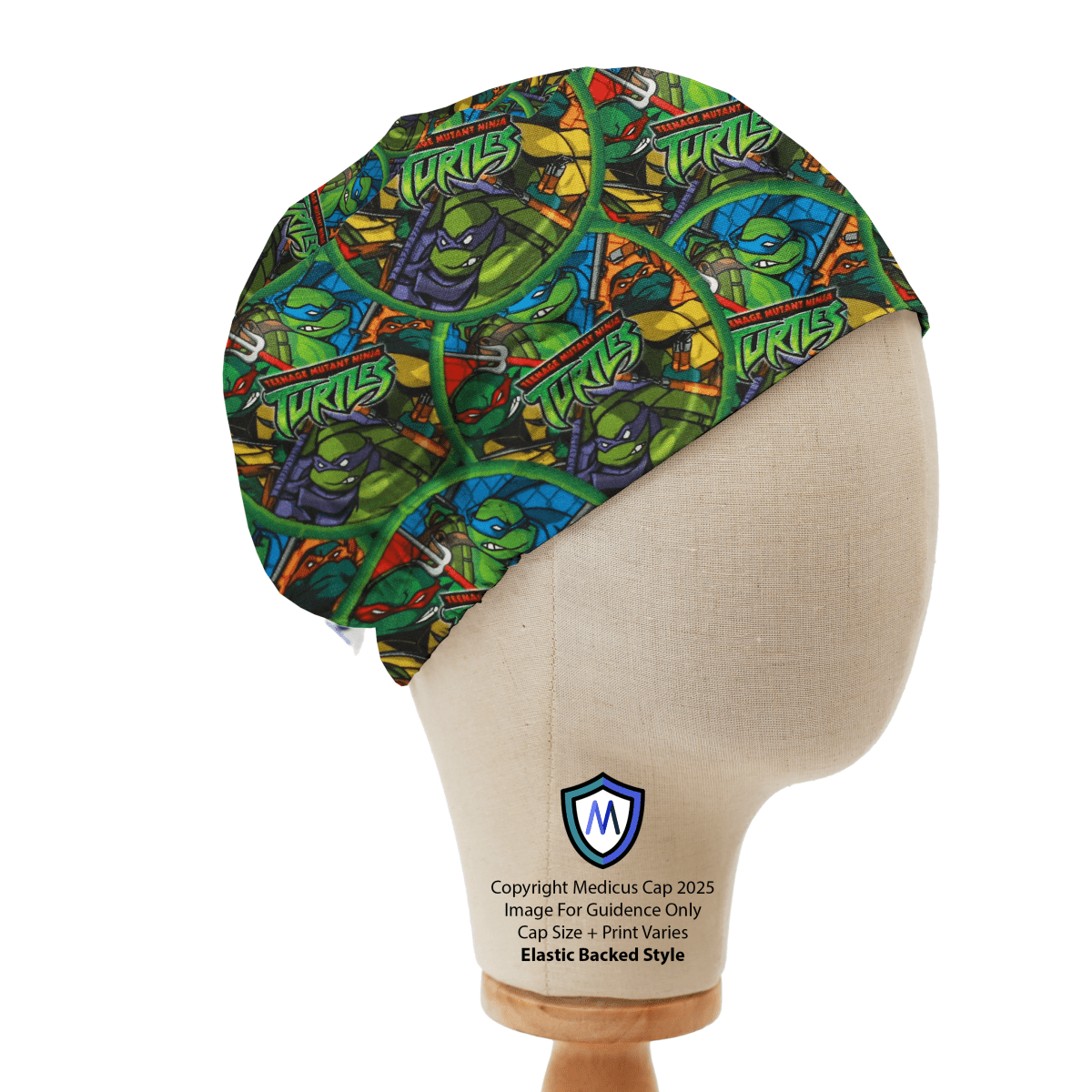 Mannequin head wearing Medicus Scrub Cap with Teenage Mutant Ninja Turtles print, on a wooden stand against a white backdrop.