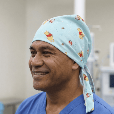 Light blue Winnie the Pooh pattern scrub cap with honey pot designs and tie-back
