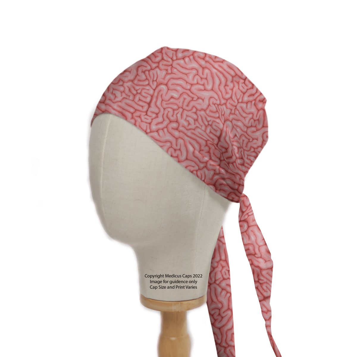 A mannequin head highlights a sustainable healthcare fashion choice with the Brains Pink Human Scrub Cap from Medicus Scrub Caps, featuring brain-like squiggles and a tie-back design. This 2022 copyrighted cap is perfect for stylish, eco-conscious healthcare professionals.