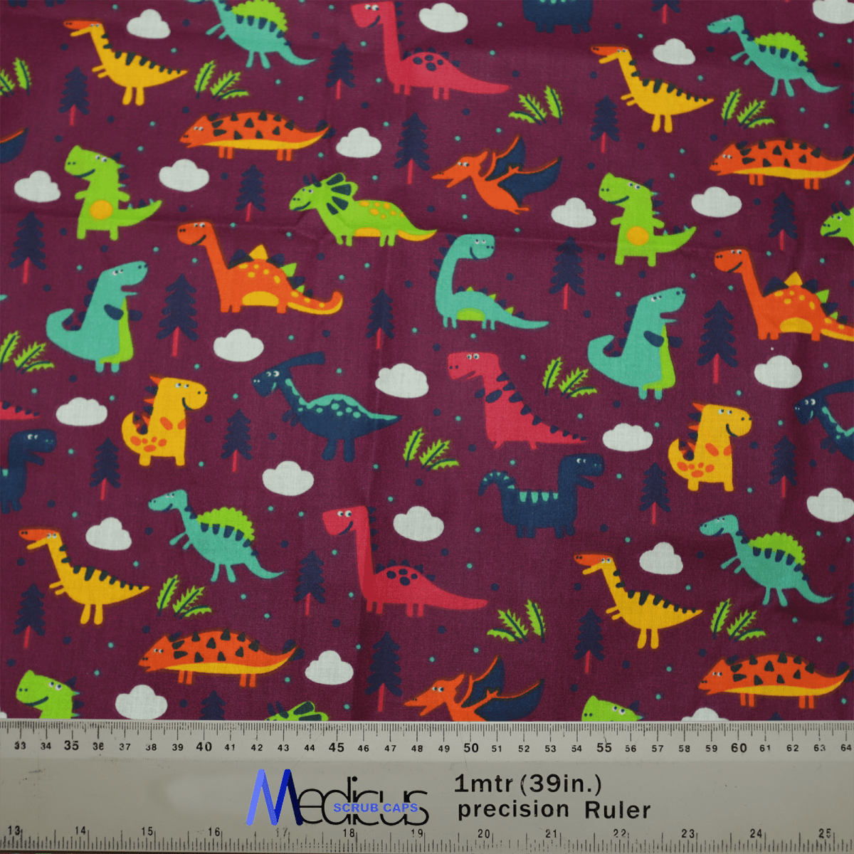 The Medicus Scrub Caps’ Dinosaurs Purple Scrub Cap is adorned with green, orange, and blue dinosaur illustrations on a purple backdrop featuring clouds and trees. It includes a ruler with inch and centimeter measurements, making it ideal for healthcare professionals who love paleontology.