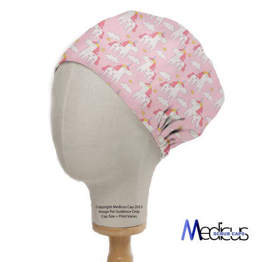 A mannequin head displays the Unicorn Cartoon Pink Scrub Cap by Medicus Scrub Caps, featuring rainbow manes for a whimsical healthcare look. Fitted against a white background, the brands logo at the bottom right signifies their quality sustainable scrub caps.