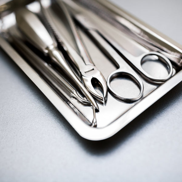 Surgical instruments on a stainless steel tray