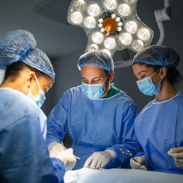 Surgical team operating together in a theatre