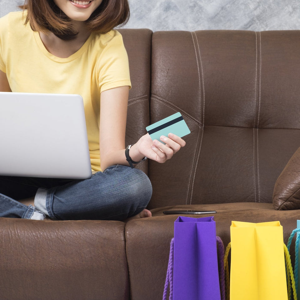 Online shopping with laptop and shopping bags