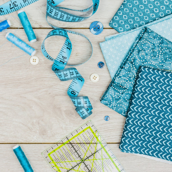 Tape measure, ruler and sewing items on a desk