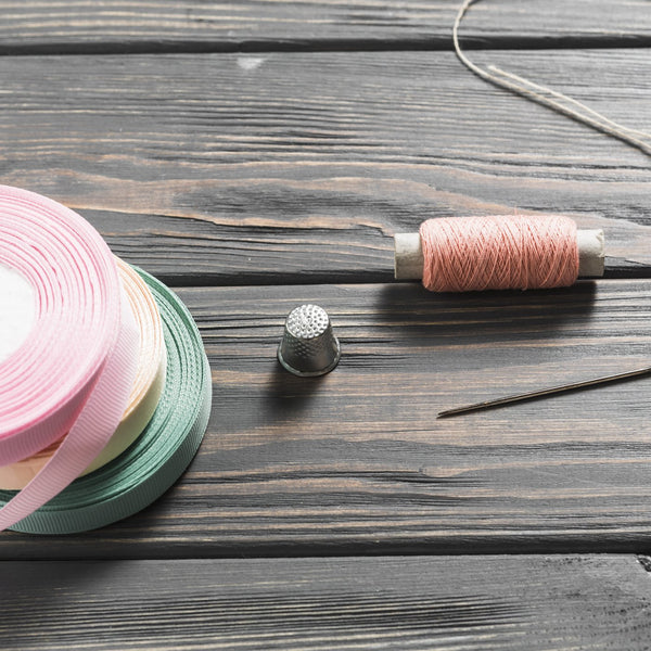 Rolled ribbons and elastic in a sewing kit