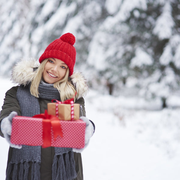 Person holding wrapped Christmas presents