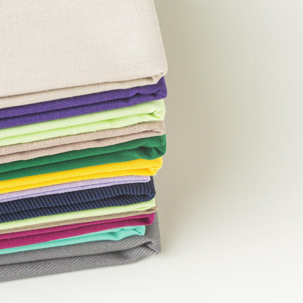 Neat stack of folded coloured fabrics