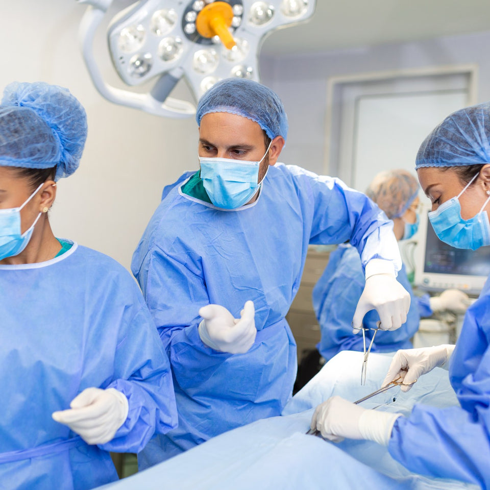 Surgical team wearing scrub caps in an operating theatre