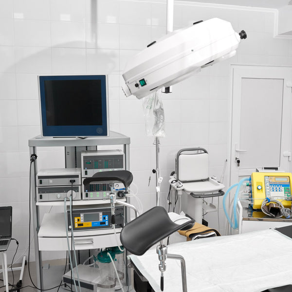 Empty hospital operating room with surgical equipment and monitors