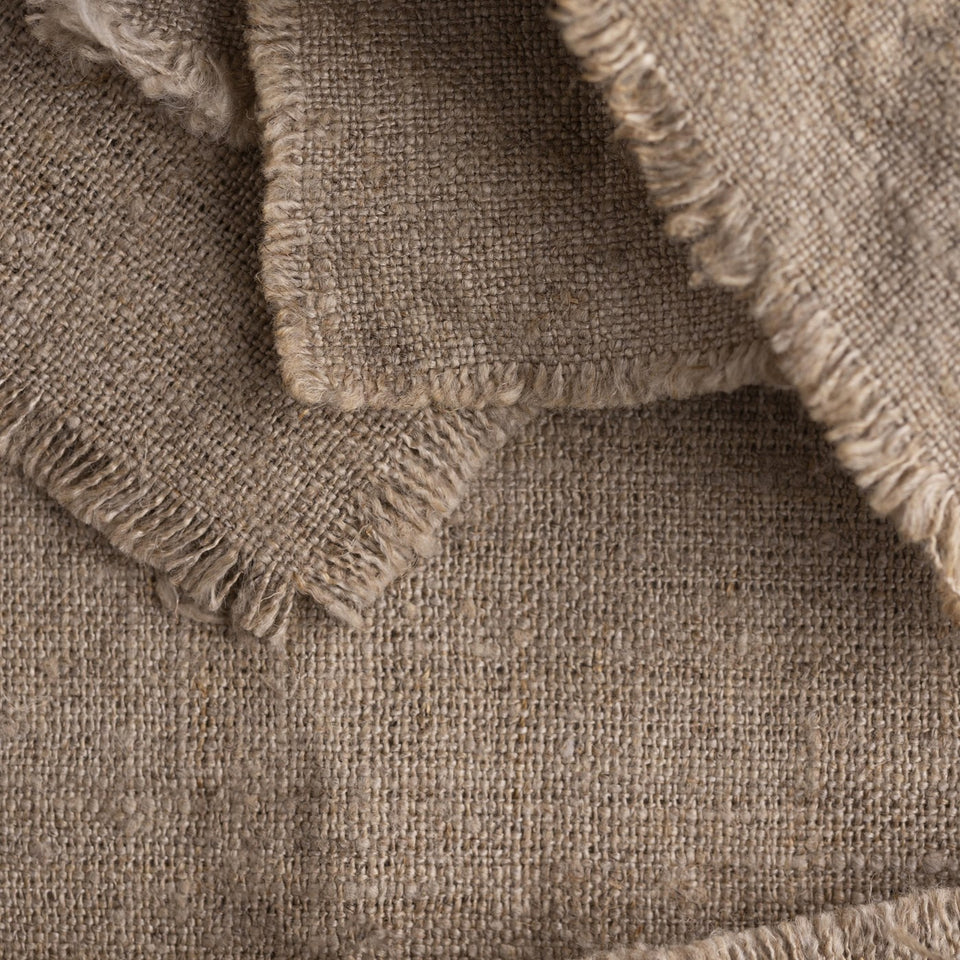 Close-up of natural hemp fabric texture with frayed edges