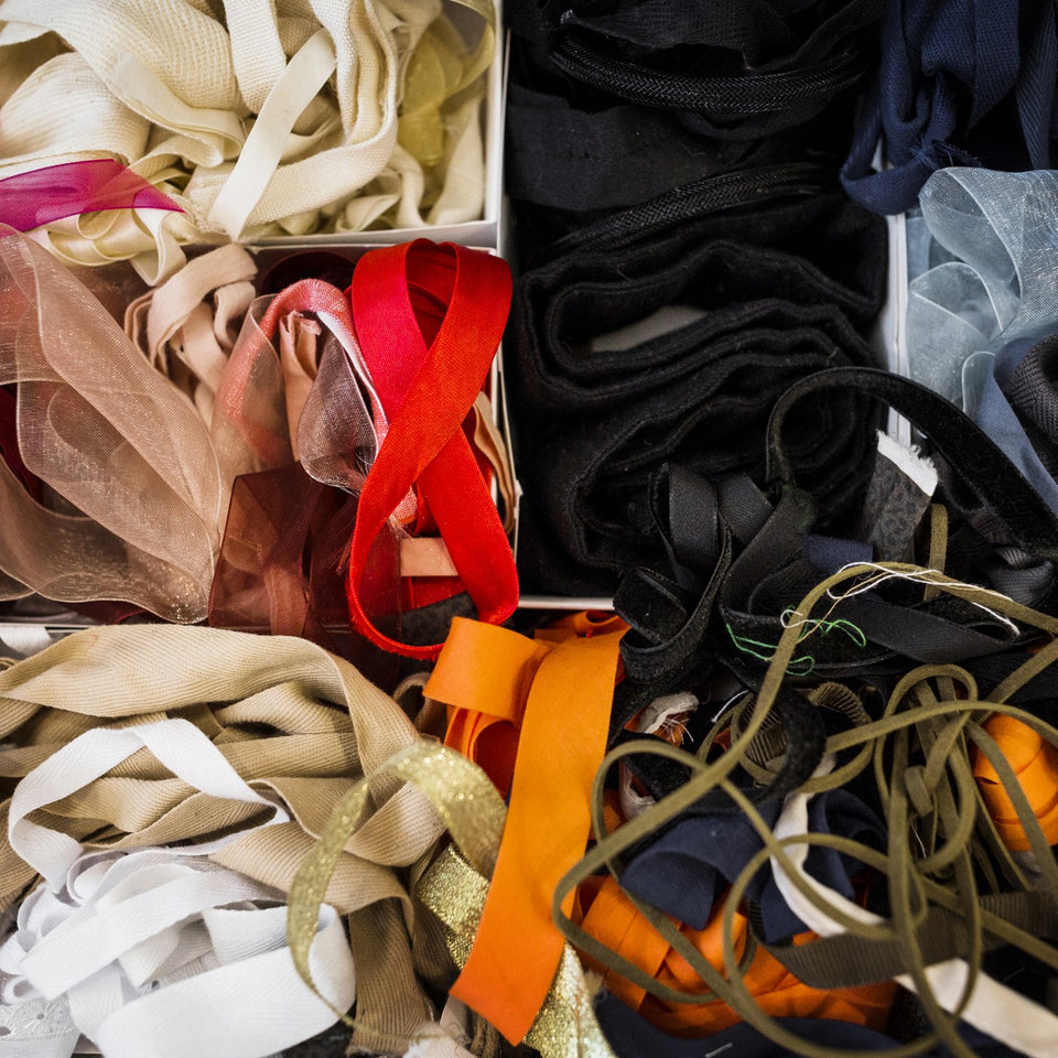 Pile of assorted fabric ribbons and textile offcuts in a tailor's shop