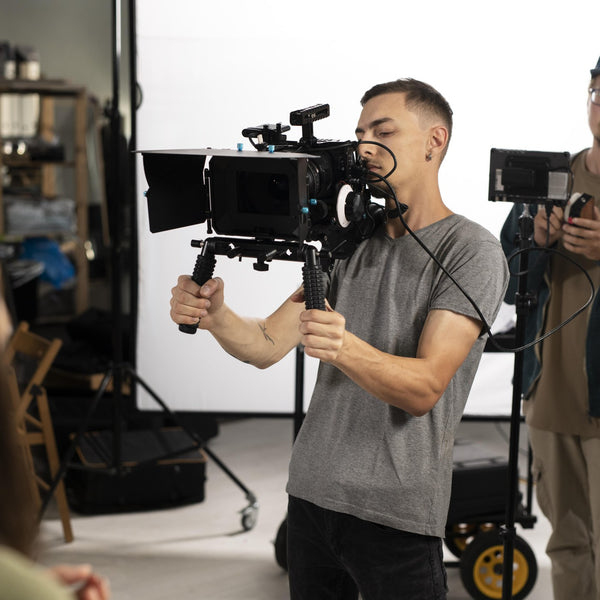Camera operator filming with a professional cinema camera on a film set
