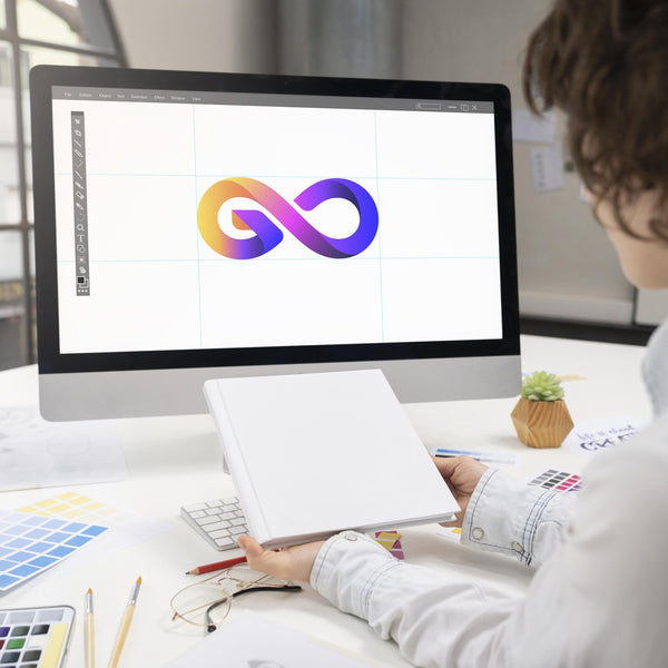 Graphic designer working on a colourful logo on an iMac with colour swatches