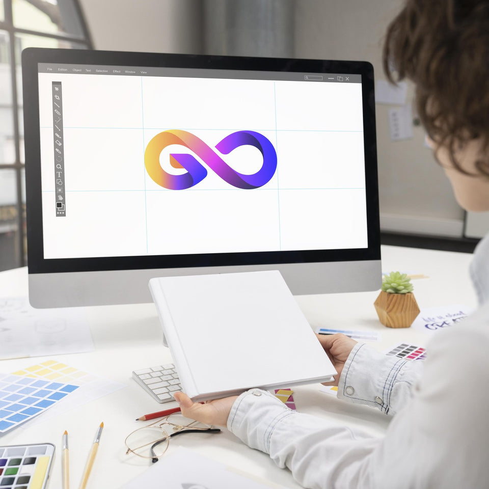 Graphic designer working on a colourful logo on an iMac with colour swatches