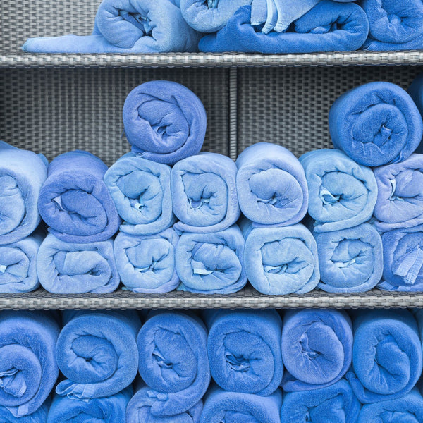 Shelves stacked with rolled blue medical garments