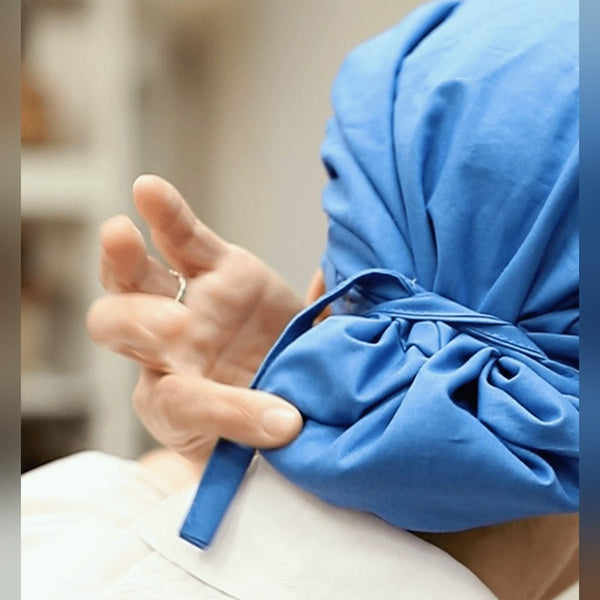 Person with long hair wearing a scrub cap showing best styles for long hair