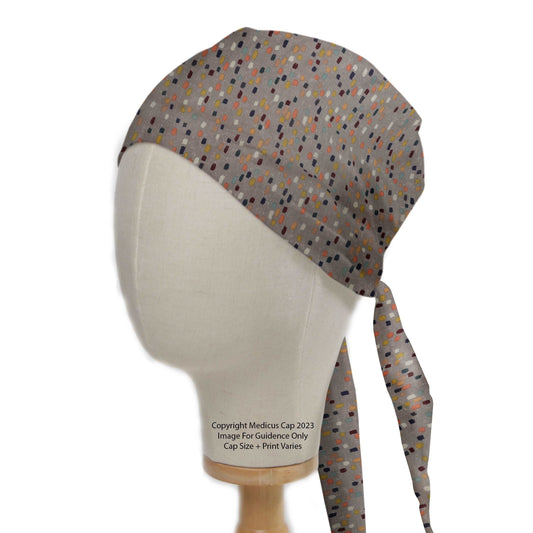 Abstract Crowd Scrub Cap from Medicus Scrub Caps, featuring a multicolored dotted pattern on a neutral background with adjustable ties for a secure fit.