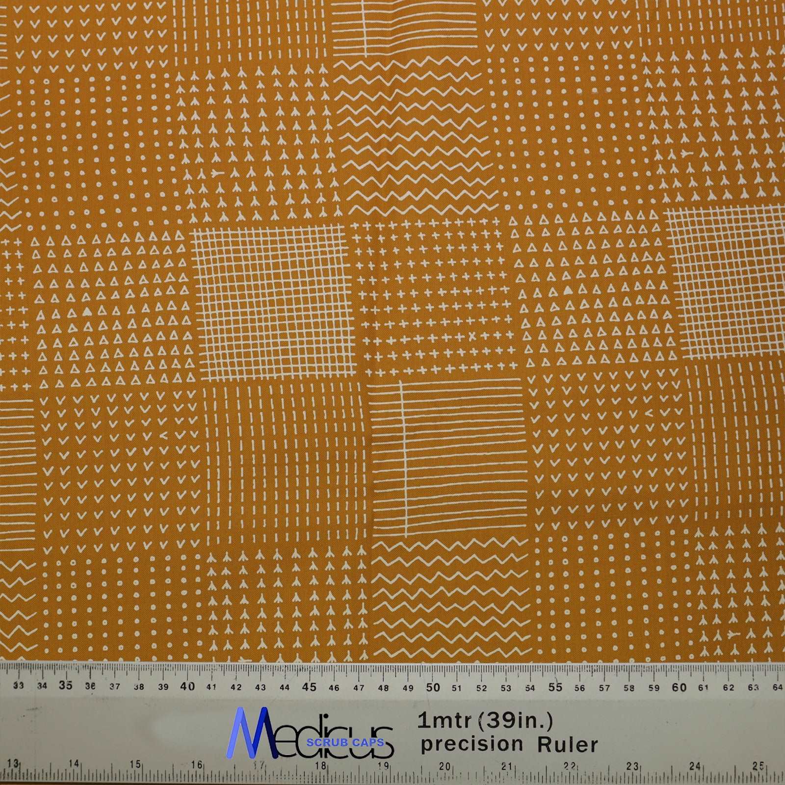 Abstract Lines On Mustard Theatre Scrub Cap from Medicus Scrub Caps, featuring a geometric patchwork design in white on a mustard background.