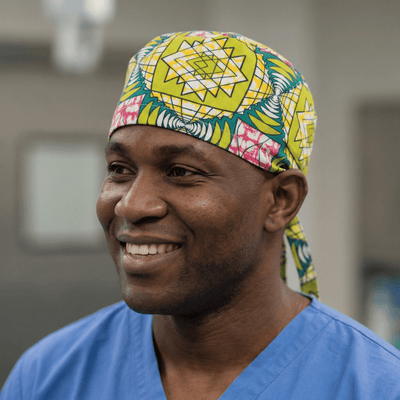 African Geo Starburst (Green, Yellow & Pink) scrub cap shown on model