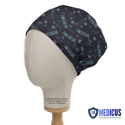 A mannequin displays a Medicus Scrub Caps Anaesthetist Anaesthesia scrub cap with a black background, featuring blue anesthesia text and patterns.
