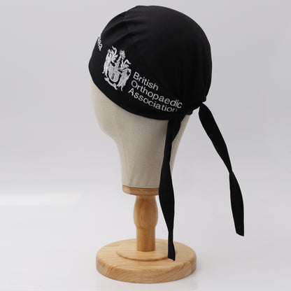 Black Medicus Scrub Cap with British Orthopaedic Association embroidery, displayed on a mannequin. Adjustable tie-back design. @boa-official-scrub-cap
