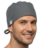 Man wearing a gray scrub cap and shirt on a white background