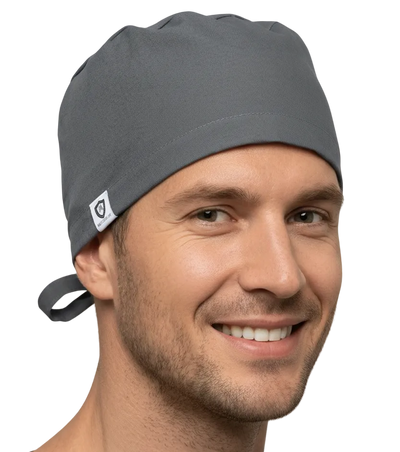 Man wearing a gray scrub cap and shirt on a white background