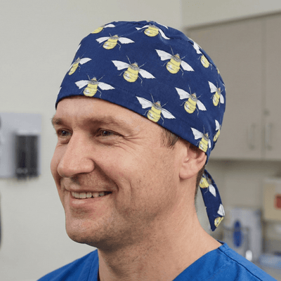 Bees On Navy scrub cap shown on model