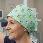 Bees On Teal scrub cap shown on model