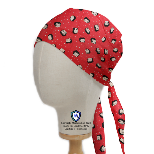 The Medicus Betty Boop On Red Scrub Cap showcases a playful cartoon pattern on red fabric with ties at the back, perfect for healthcare professionals.