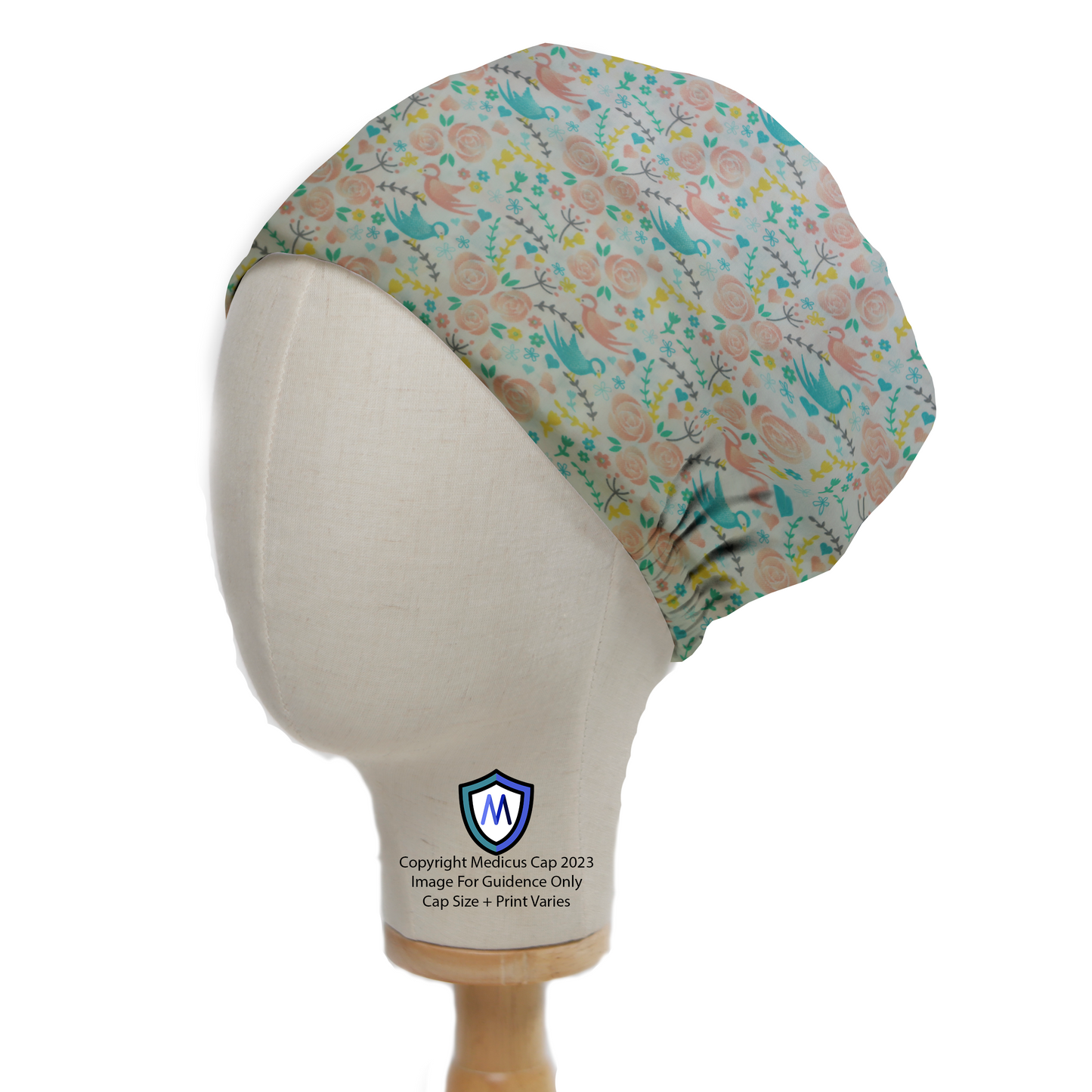 Birds Floral Blue and Pink Scrub Cap from Medicus Scrub Caps, featuring a delicate bird and floral pattern on a soft blue background.