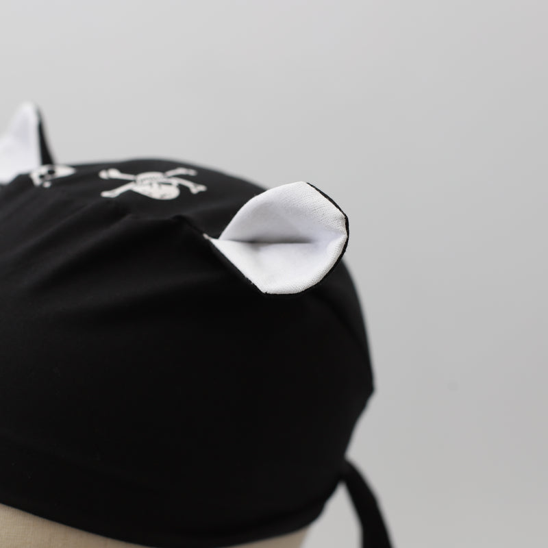 A scrub cap with fabric bunny ears on the crown