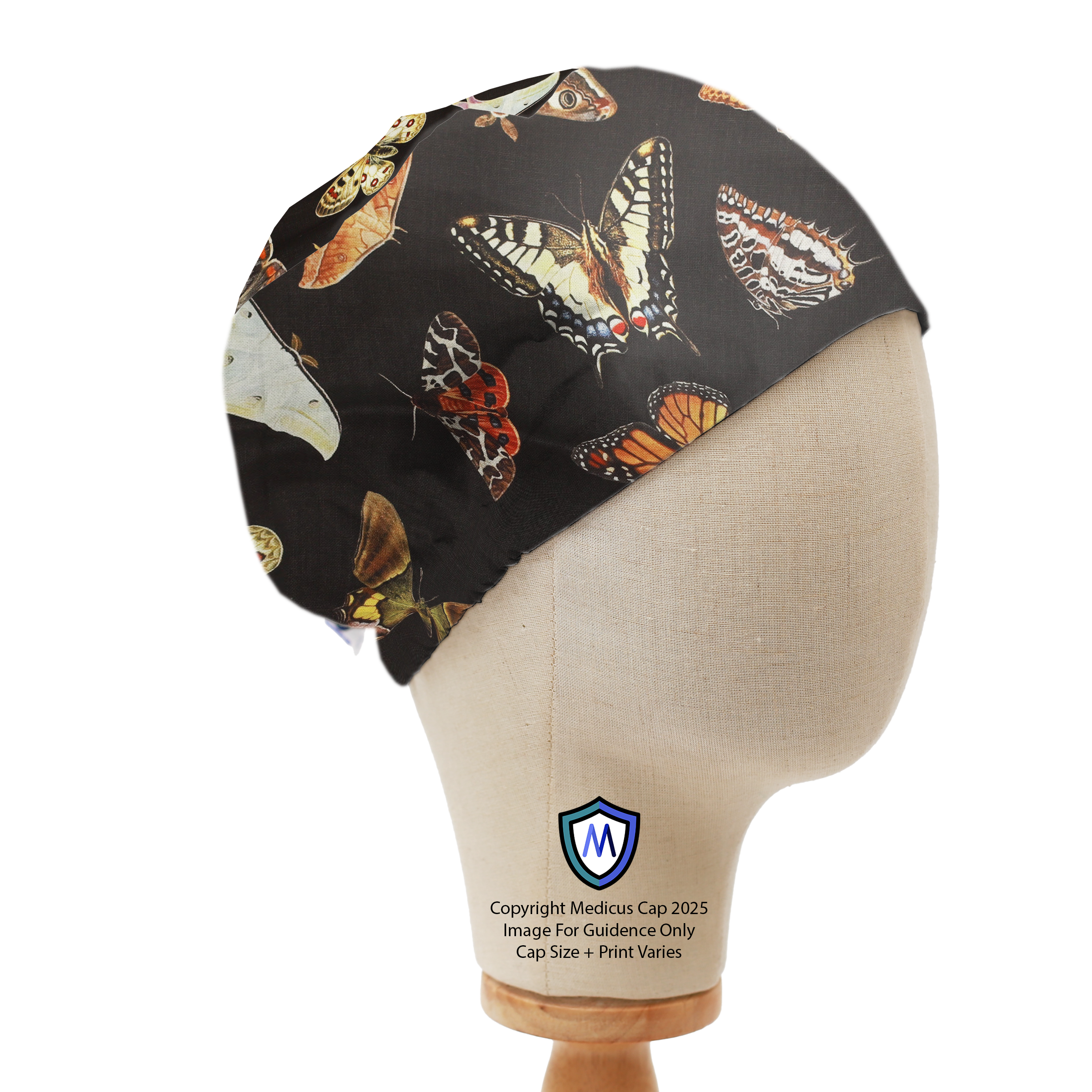 Mannequin head wearing a Medicus Scrub Cap with colorful butterflies and moths on a black background, elastic-backed.