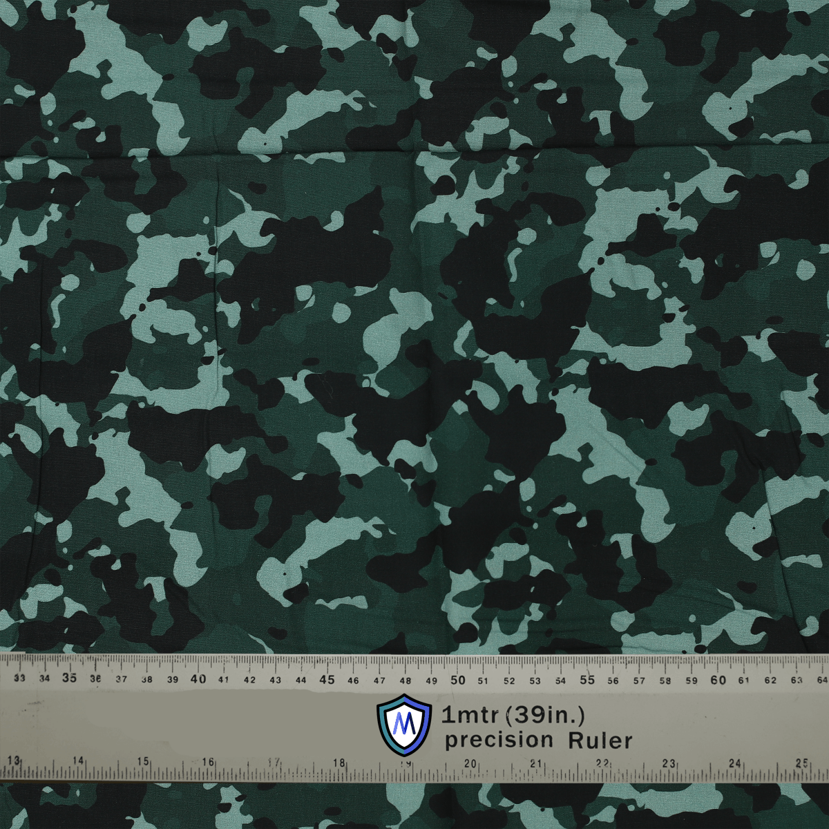 Dark green camouflage fabric with a ruler for scale, ideal for Medicus Scrub Caps, offering a stylish and professional look for medical professionals.