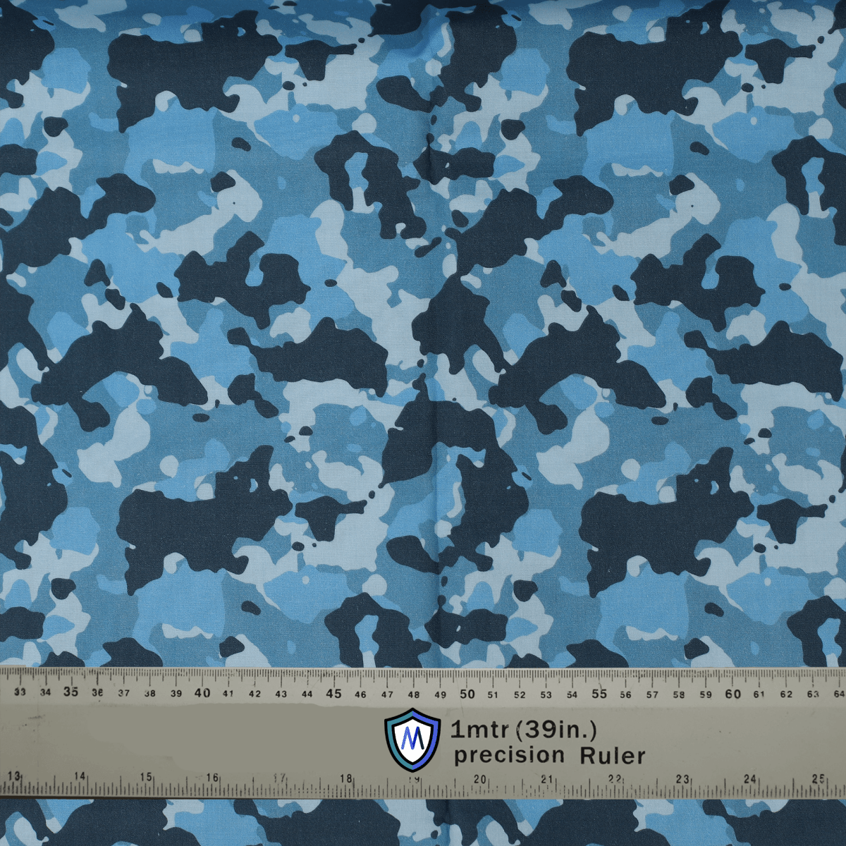 Blue camouflage fabric for Medicus Scrub Caps, measured with a precision ruler for accuracy.