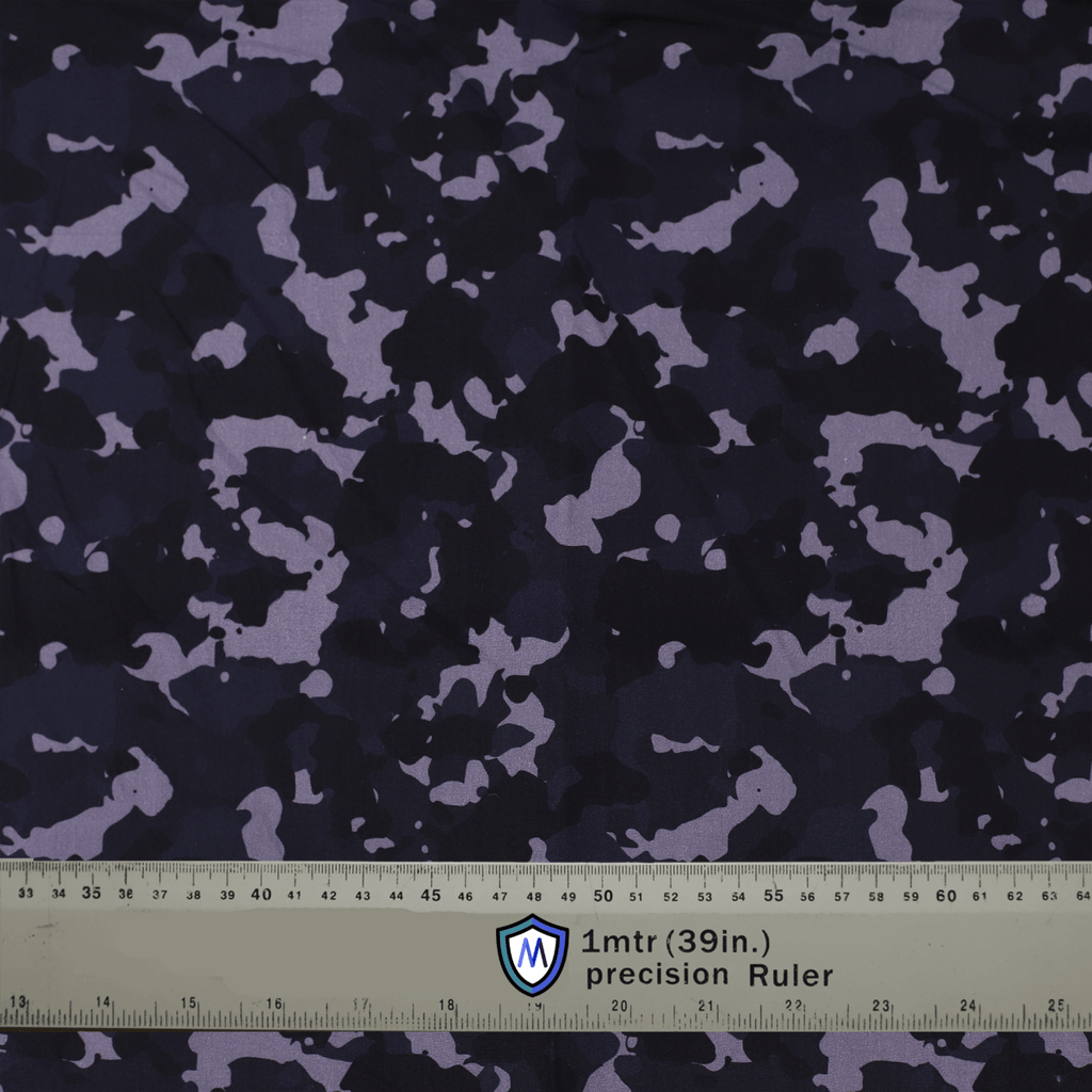 Dark camouflage fabric used for Medicus Scrub Caps, with a precision ruler for scale. Ideal for stylish and functional medical headwear.