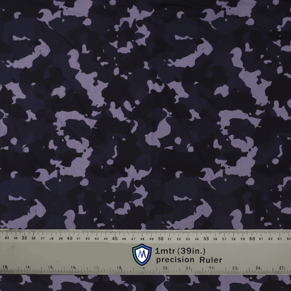 Dark camouflage fabric used for Medicus Scrub Caps, with a precision ruler for scale. Ideal for stylish and functional medical headwear.