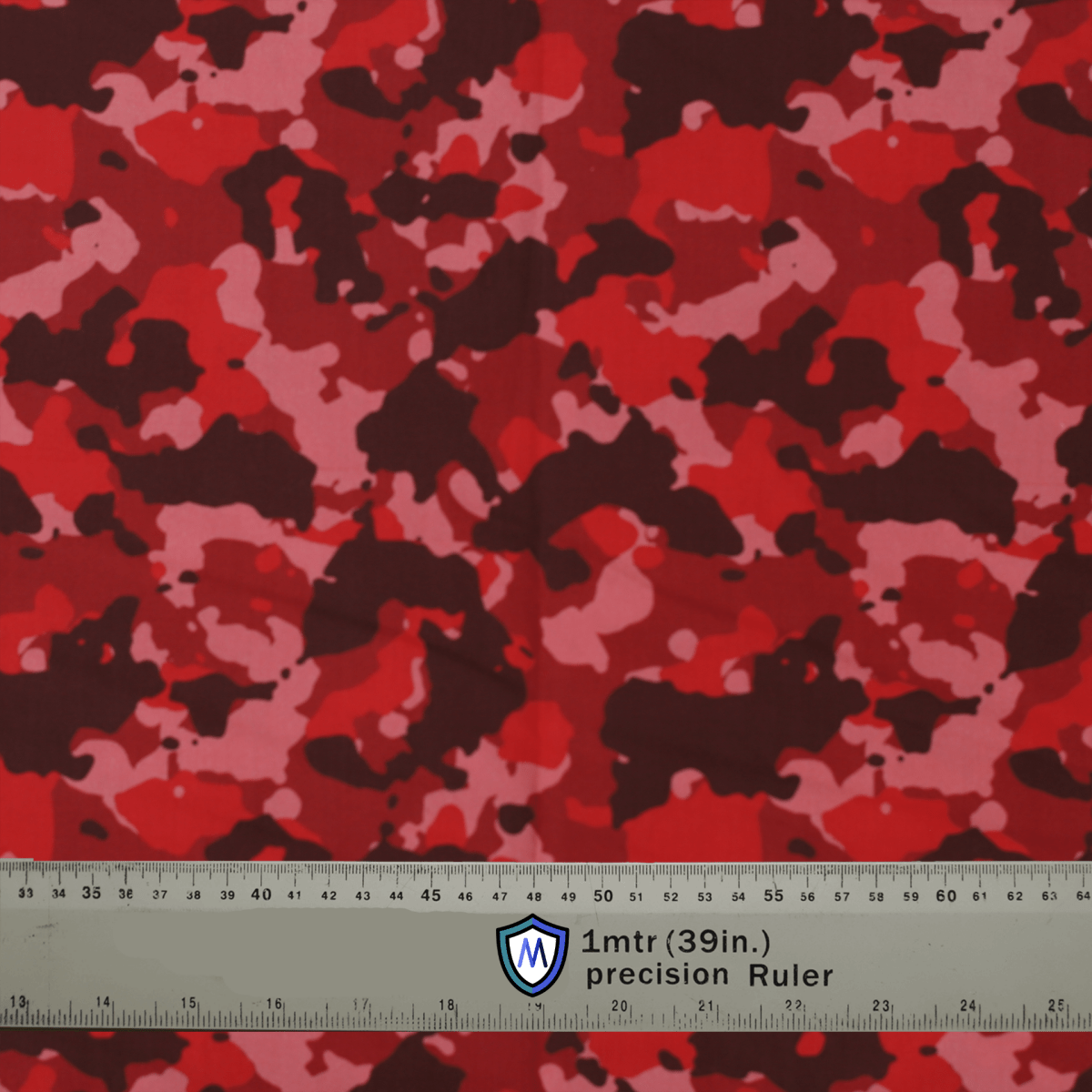 Red camo fabric for Medicus Scrub Caps with a precision ruler for scale. Bold, stylish design for medical professionals.