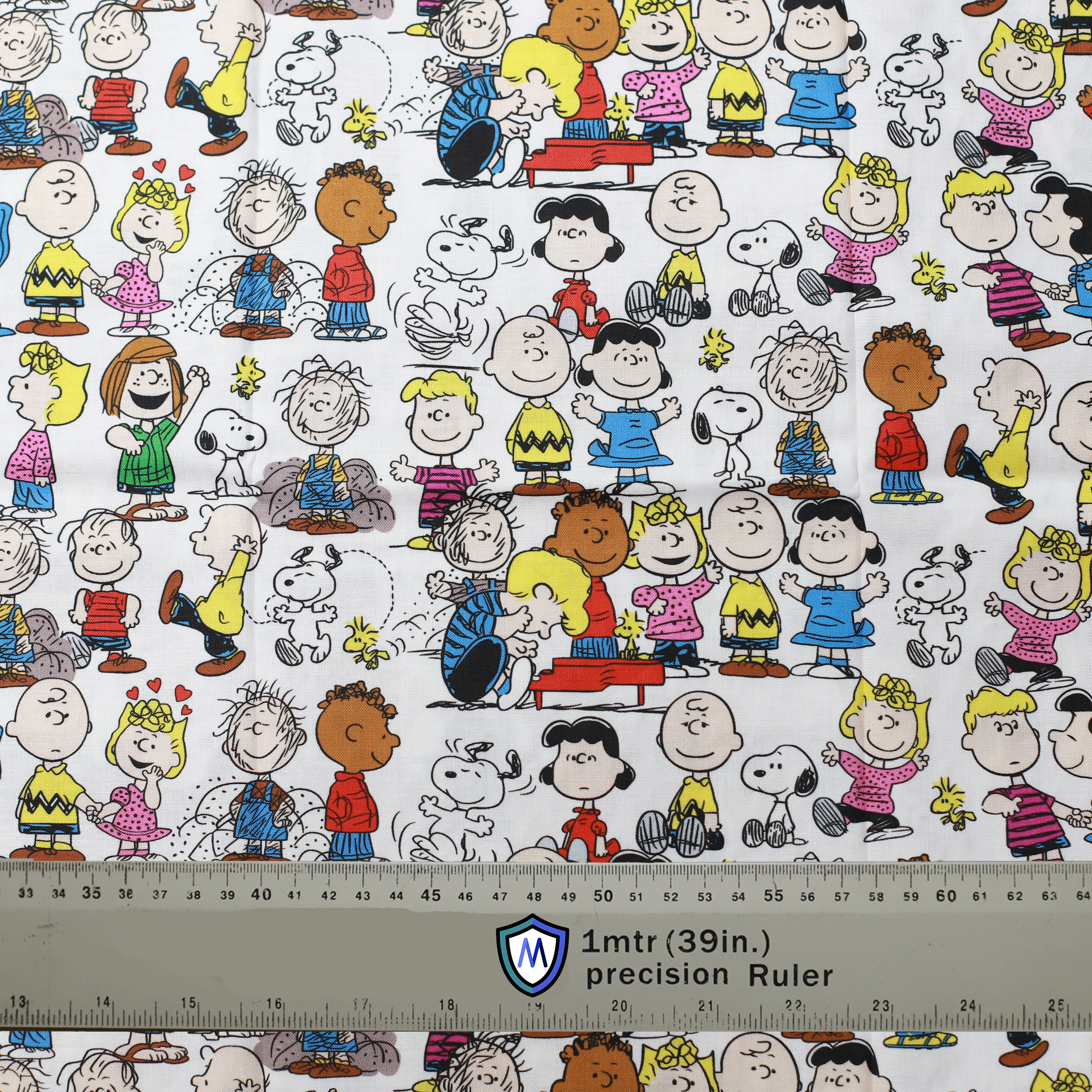 Fabric sample featuring Peanuts characters on a white background, ideal for a Medicus Scrub Cap. 1-meter ruler for scale.