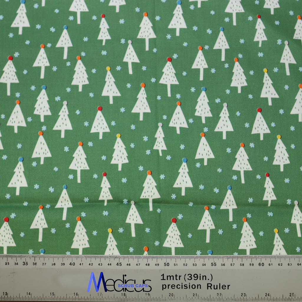 The Christmas Tree Forest Scrub Cap by Medicus features a green fabric with white trees, colorful dots, and snowflakes, evoking a festive winter forest scene.