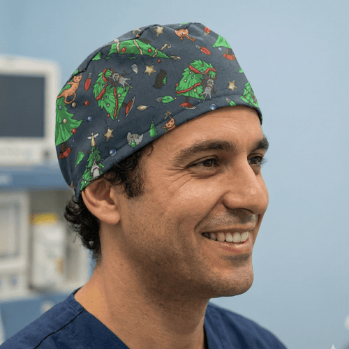 Christmas Cats Ruin Tree scrub cap shown on model