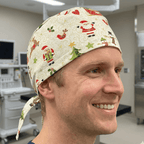Christmas Santa Wrapping paper scrub cap shown on model